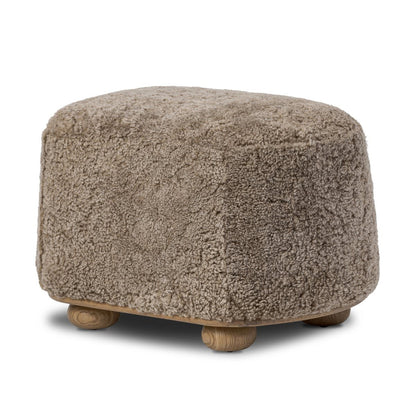 Pouf ovale Bilbury à quatre mains en peau lainée taupe